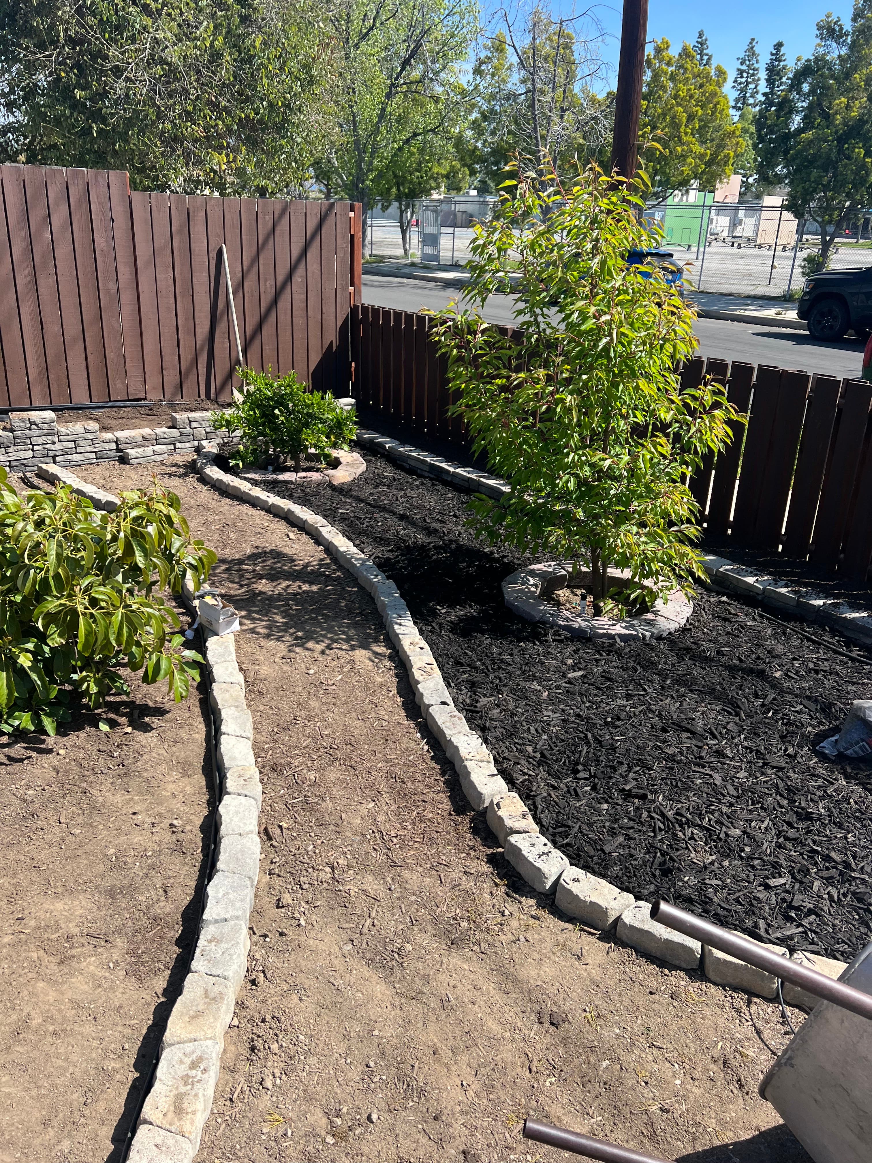 Picture of remodeled backyard with pavers and beautiful landscaping 